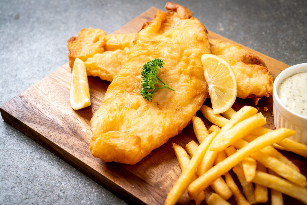 plated fish and chips on a board