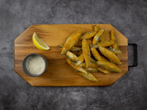 Lightly Dusted Whitebait on a board