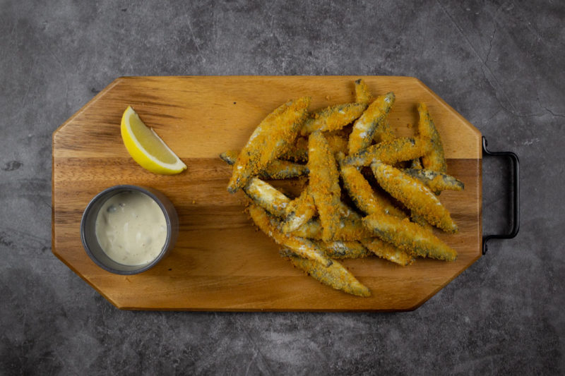 lightly dusted whitebait on a board